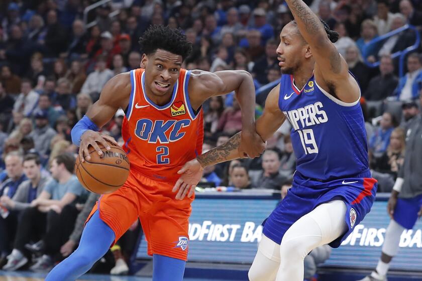 Oklahoma City Thunder guard Shai Gilgeous-Alexander (2) drives to the basket around Los Angeles Clippers guard Rodney McGruder (19) during the second quarter of an NBA basketball game Sunday, Dec. 22, 2019, in Oklahoma City. (AP Photo/Alonzo Adams)