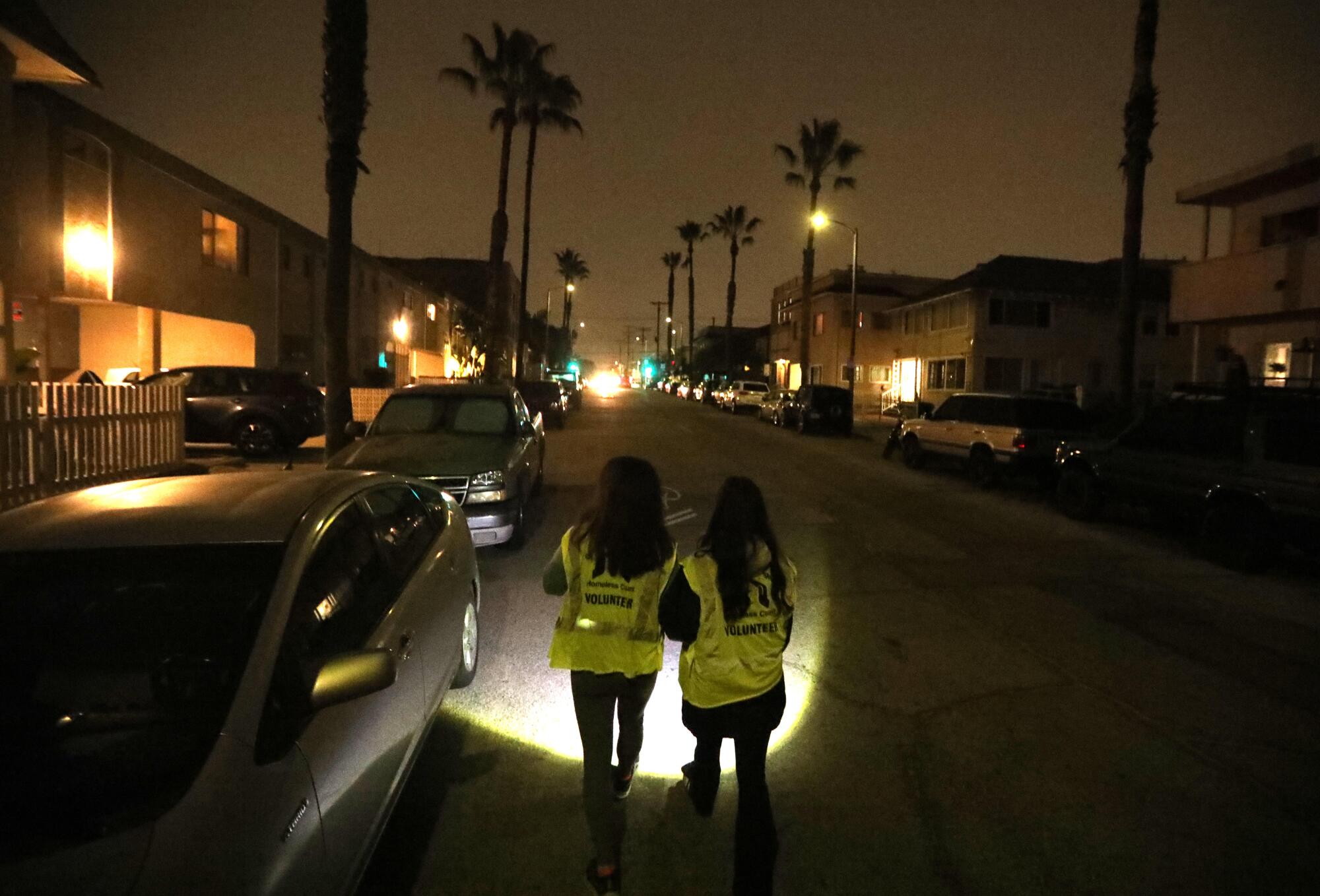 Wah Chen, left, and her daughter, Rainey Renwick, walk along Rose Avenue looking for homeless people in Venice.