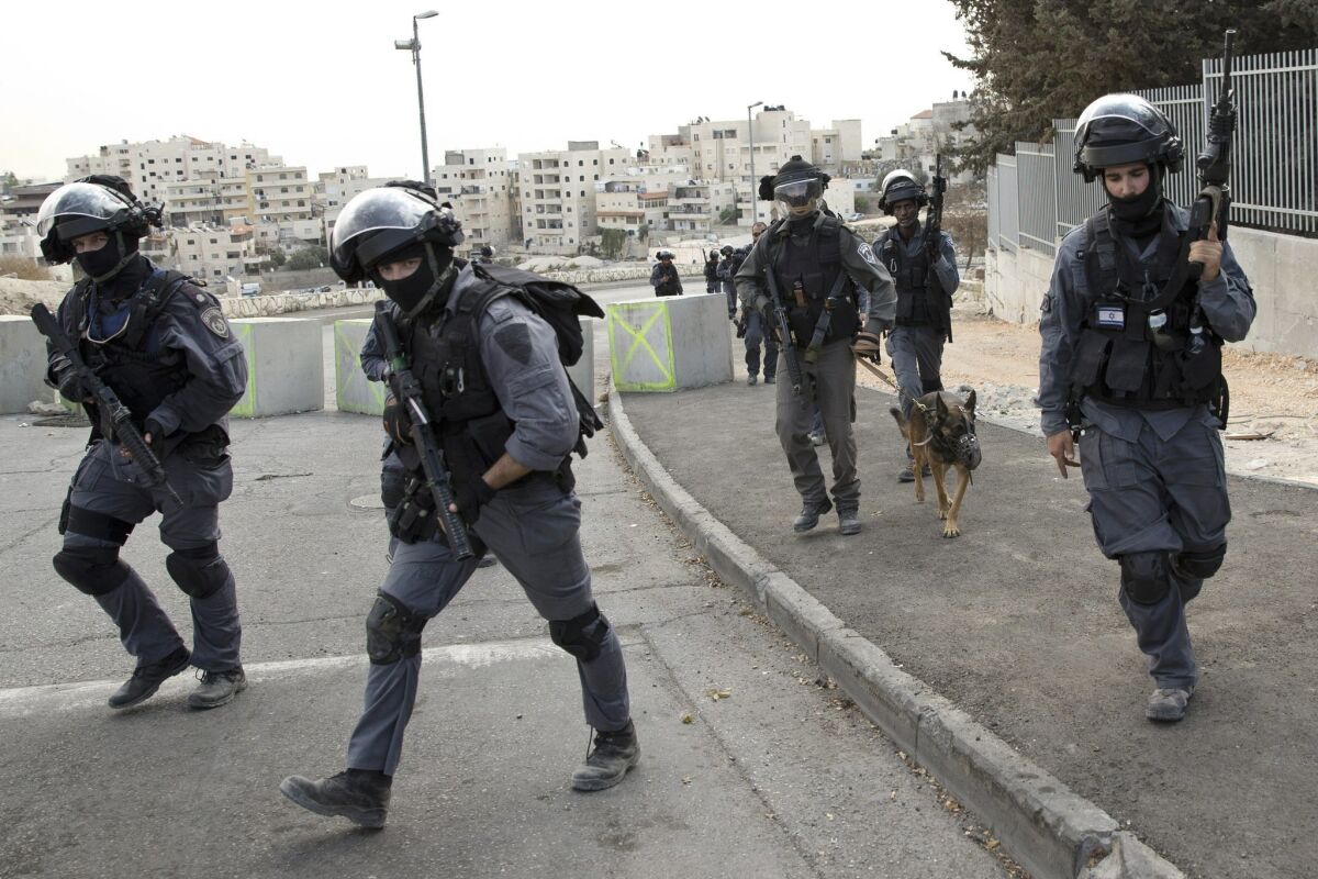 Israeli riot police officers operate in the Arab neighborhood of Issawiyeh in Jerusalem, Tuesday, Oct. 20, 2015. 