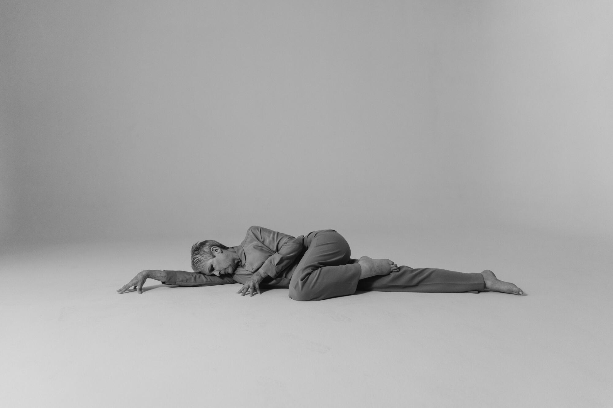 Jamie Lee Curtis looks lean and elegant as she stretches out on the floor for a portrait.