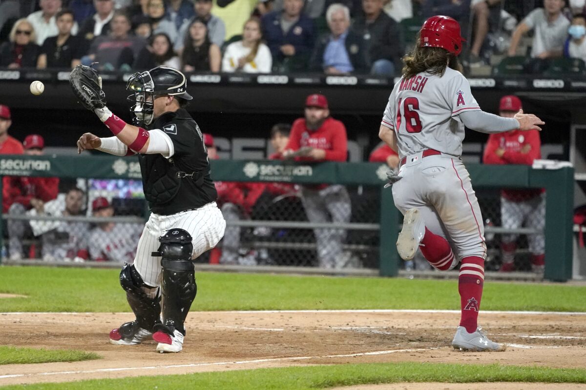 Los Angeles Angels' Brandon Marsh (16) scores past Chicago White Sox catcher Yasmani Grandal during the sixth inning of a baseball game Wednesday, Sept. 15, 2021, in Chicago. (AP Photo/Charles Rex Arbogast)