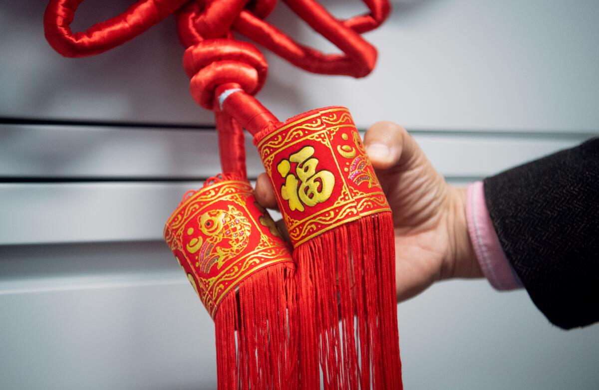 A decoration with the Chinese word for "happiness" inscribed on it hangs in an empty classroom at San Francisco State University.