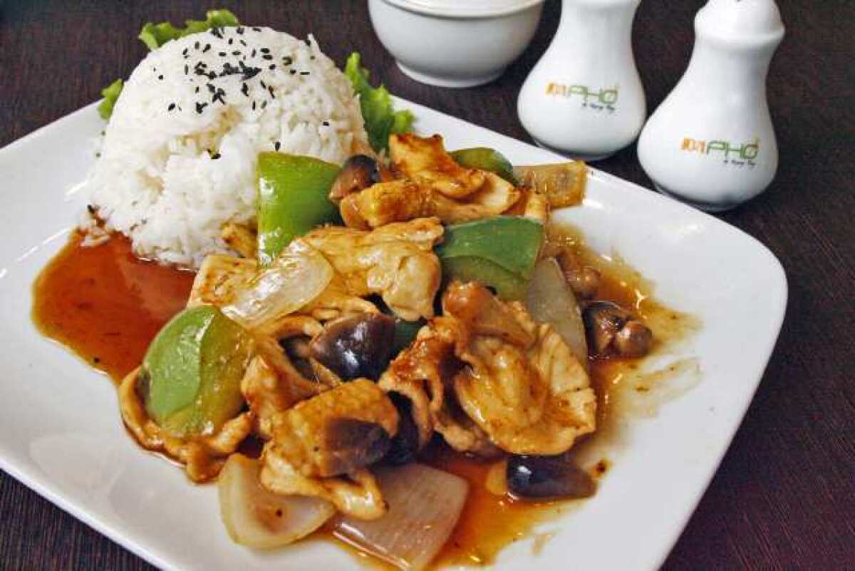 9021Pho's chicken tamarind plate is served with bell pepper, onion, straw-mushroom, baby corn, tamarind sauce and jasmine rice.