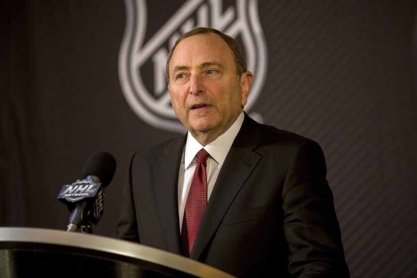FILE - In this Dec. 4, 2018, file photo, National Hockey League Commissioner Gary Bettman speaks at a press conference at the Board of Governors annual meeting in Sea Island, Ga. Bettman says players and staff have been told to stay away from the rink and self-isolate while the league is on a hiatus of uncertain length. Bettman said in a phone interview Friday, March 13, 2020, with the Associated Press and the league's website that, to his knowledge, no players or league employees have tested positive for the new coronavirus.(AP Photo/Stephen B. Morton, File)