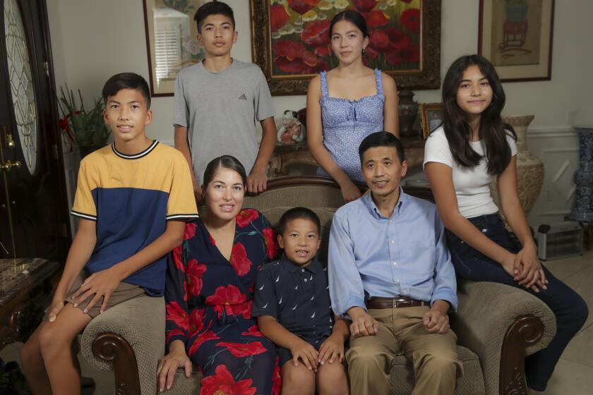 Mexican-Chinese couple Beatriz Ortega, left, and Ivan Liu with their children at their home on Sept. 22, 2021 in Rosemead.