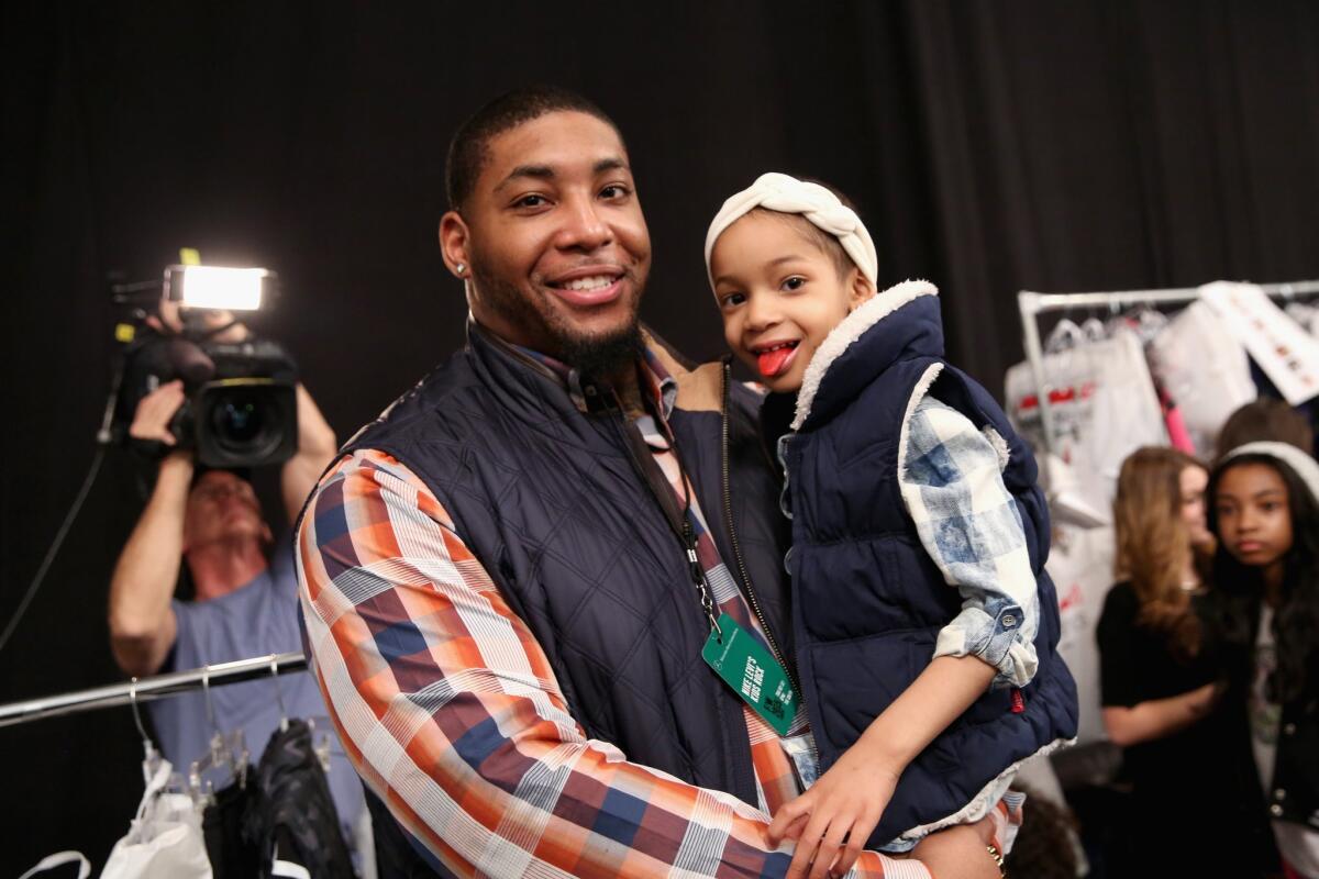 Cincinnati defensive back Devon Still and daughter Leah prepare backstage at the Nike Levi's Kids fashion show during Mercedes-Benz Fashion Week Fall 2015 at Lincoln Center on Feb. 12.