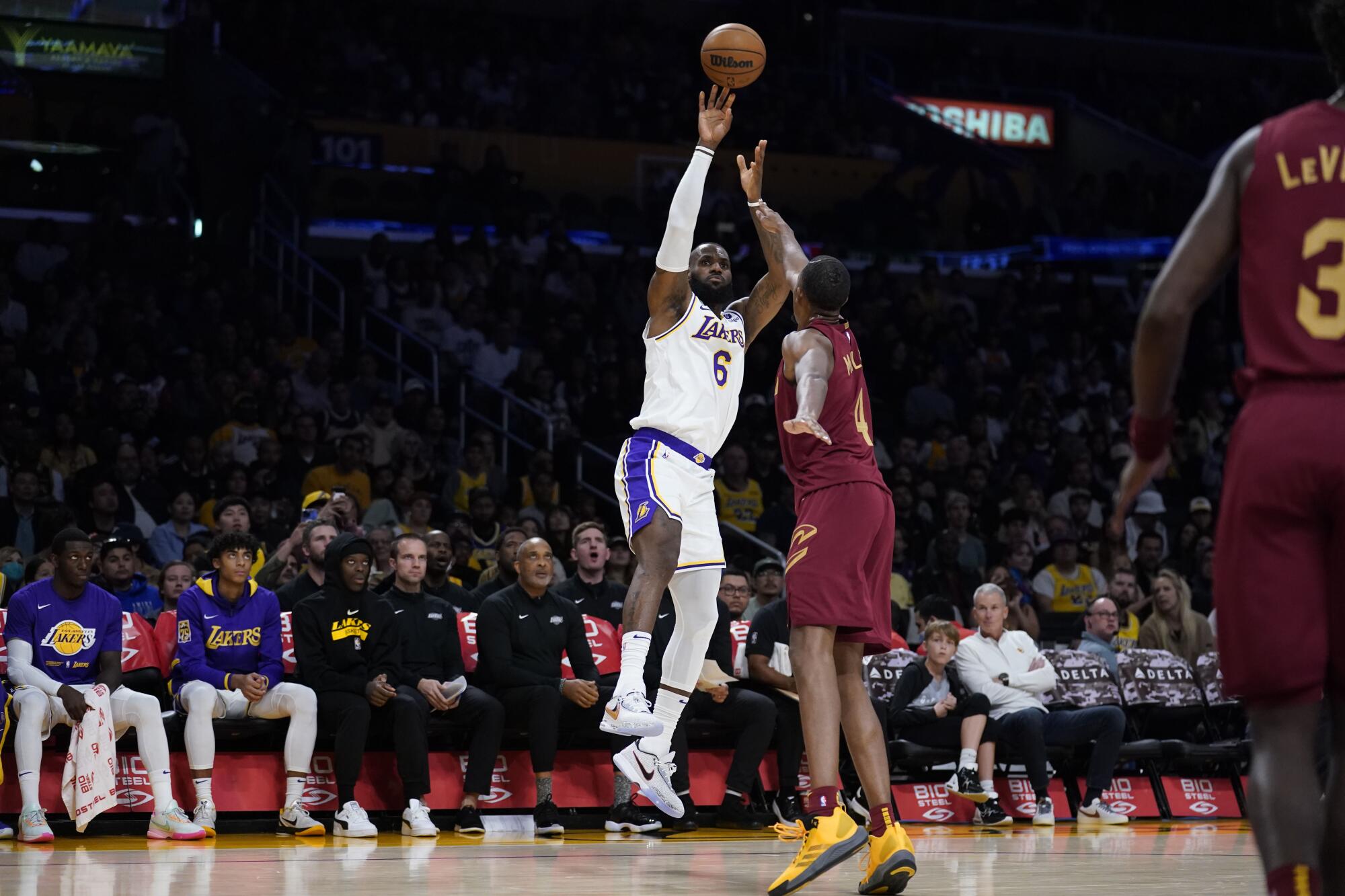 Lakers forward LeBron James shoots over Cavaliers forward Evan Mobley.
