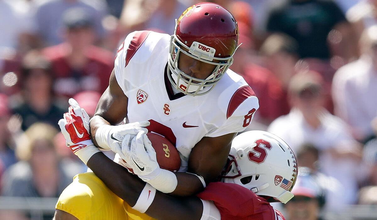 USC receiver George Farmer catches the ball while defended Stanford's Wayne Lyons on Sept. 6.