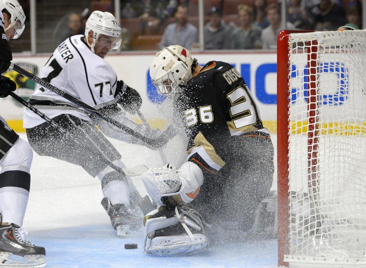 Kings forward Jeff Carter, left, scores on Ducks goalie John Gibson during the third period of the Kings' 6-0 preseason victory Tuesday.