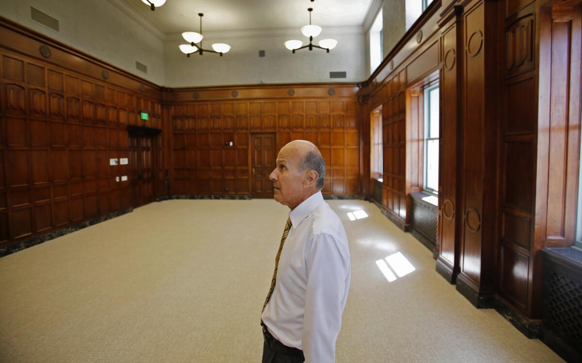Former Los Angeles County Sheriff Lee Baca admires the craftsmanship in a court chamber on the eighth floor of the of the newly refurbished 1925 Hall of Justice in Los Angeles on Oct 8, 2014. Baca was instrumental in saving the earthquake-damaged building.