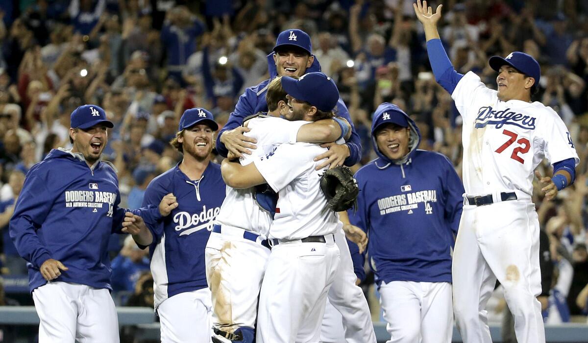Catcher A.J. Ellis is the first Dodgers teammate to embrace pitcher Clayton Kershaw after he completed his first no-hitter with a strikeout on Wednesday night.