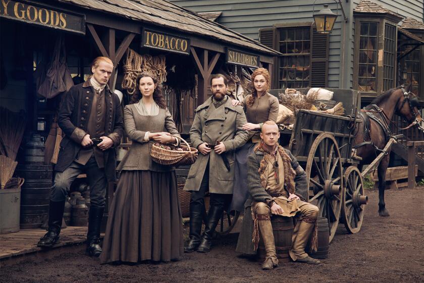 Outlander, Season 6 main characters standing in a market