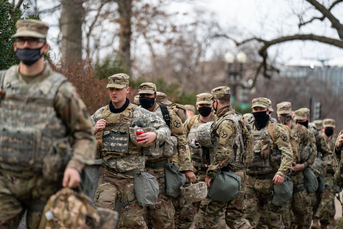 U.S. National Guard members disembark from a bus Monday in Washington, D.C.