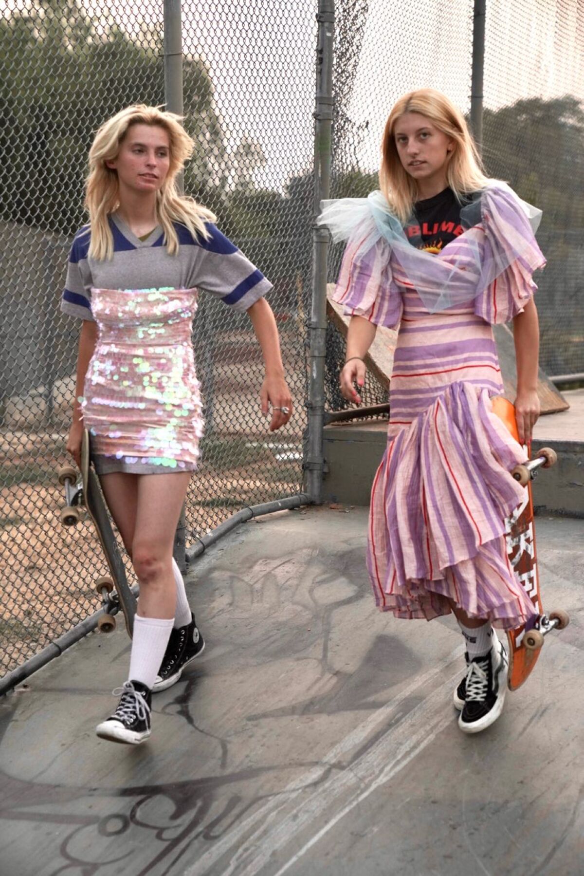 Imitation of Christ looks on models with skateboards