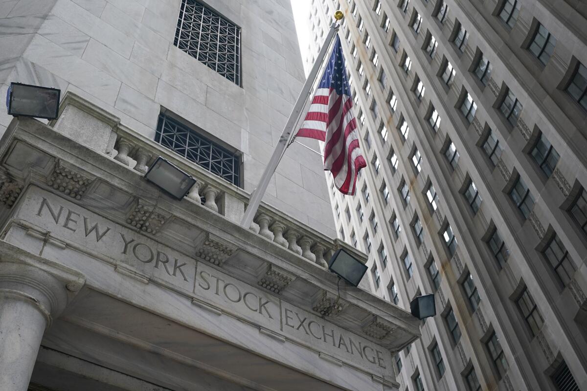 An American flag is above the words "New York Stock Exchange" ingraved into the building. 