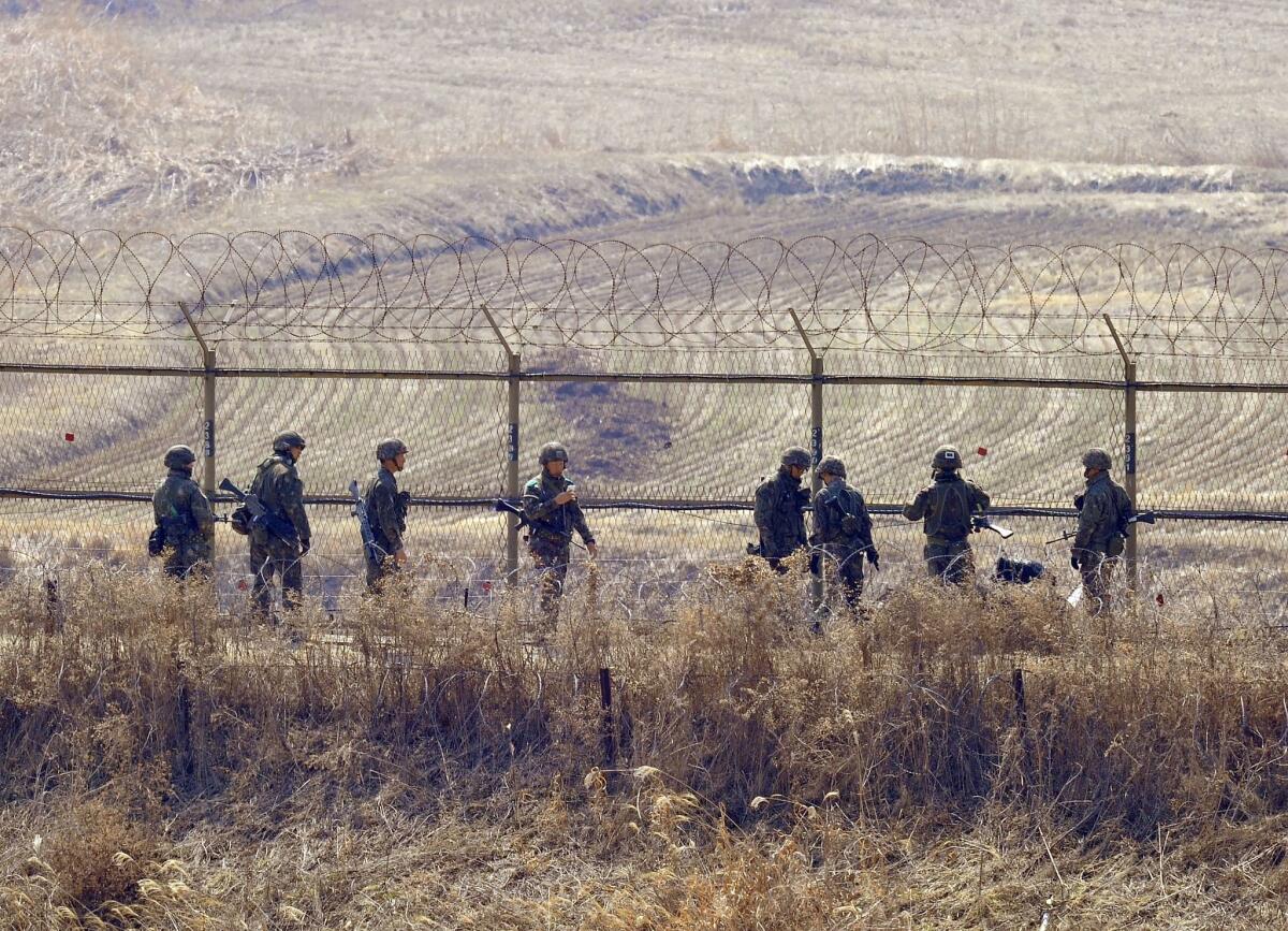 South Korean soldiers check a fence near the demilitarized zone between North and South Korea in 2003.