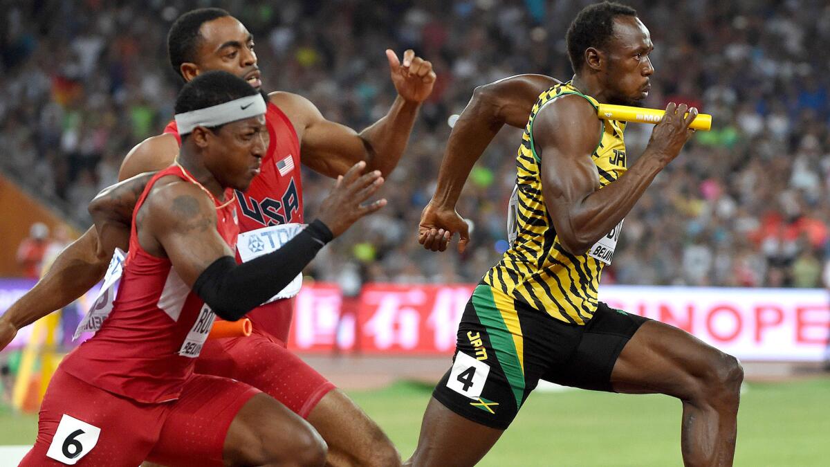 Usain Bolt (4) anchors Jamaica's winning 400-meter relay team as Americans Mike Rodgers (6) and Tyson Gay make an illegal exchange outside the passing zone at the IAAF World Championships on Saturday.