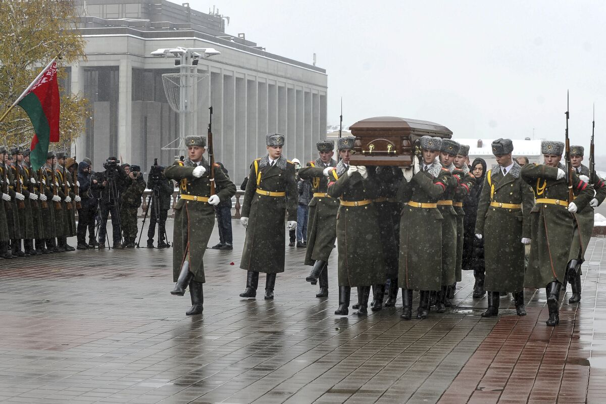 Members of the Honour Guard carry a coffin with the body of Belarusian Foreign Minister Vladimir Makei during his farewell ceremony at the Central House of Officers in Minsk, Belarus, Tuesday, Nov. 29, 2022. The foreign minister of Belarus has died at the age of 64. Vladimir Makei, was a close associate of authoritarian President Alexander Lukashenko for decades. (AP Photo)