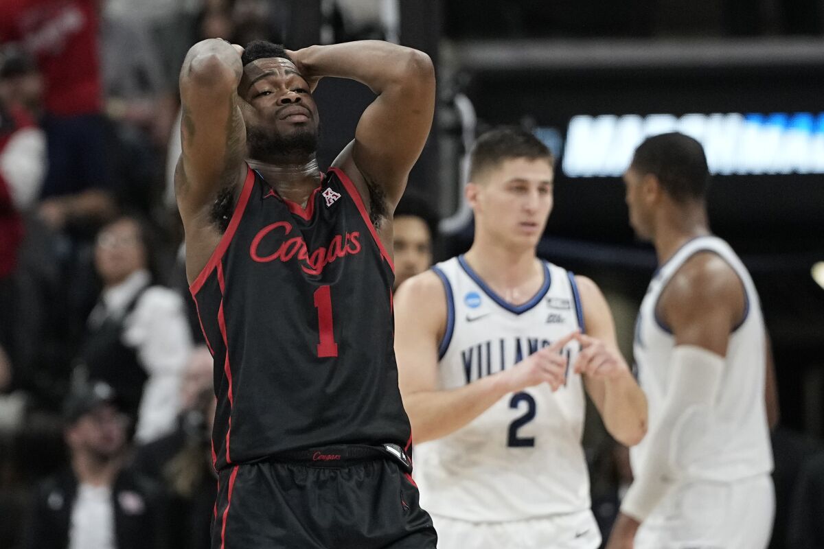Houston's Jamal Shead (1) reacts against Villanova on March 26, 2022. The Wildcats' Collin Gillespie (2) is at back.