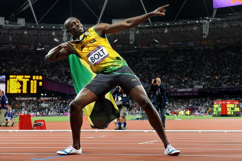 Jamaica's Usain Bolt strikes a pose after winning the gold medal in the 100 meters at the 2012 London Olympics.