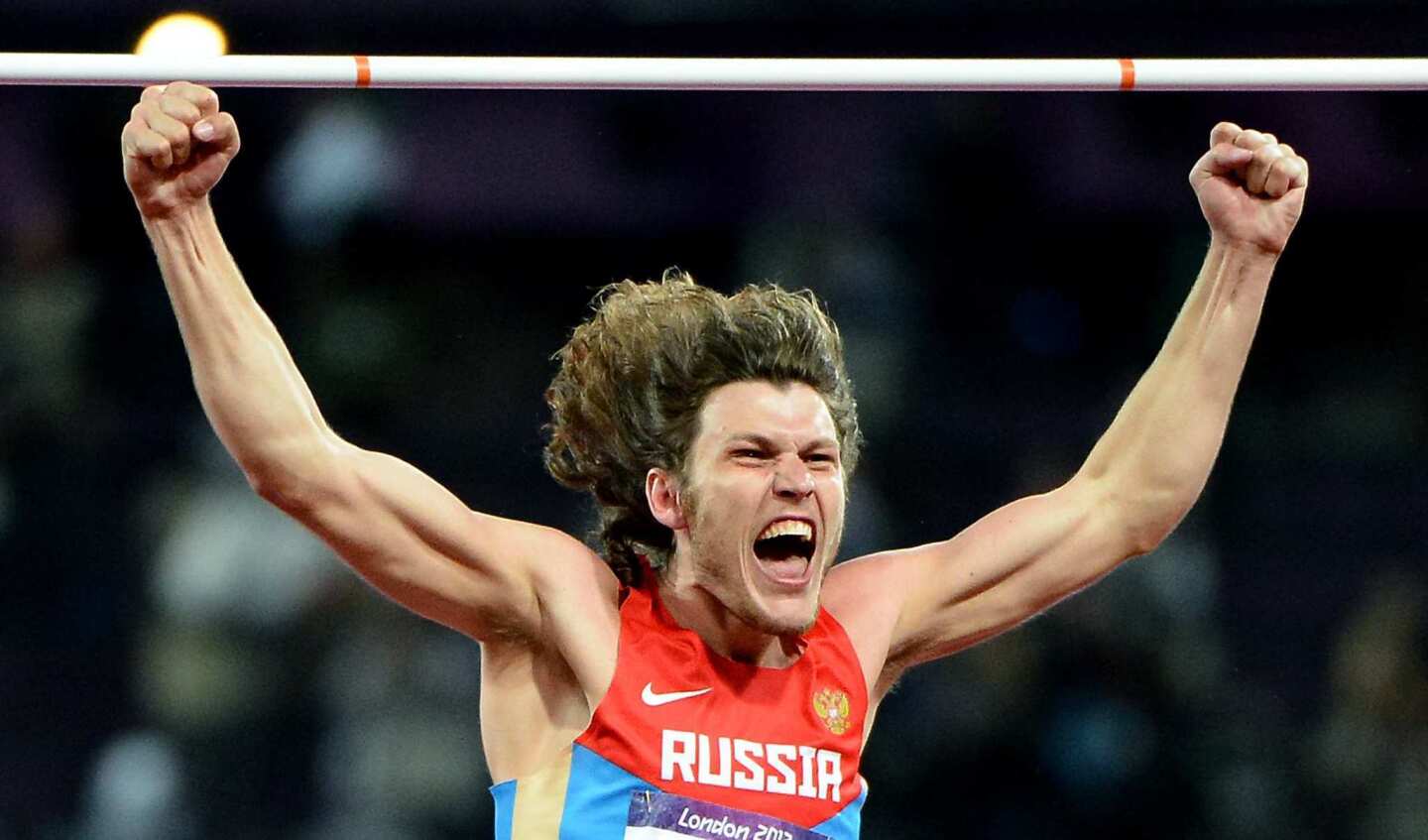 Russia's Ivan Ukhov wins the gold medal after clearing the bar in the high jump. Erik Kynard of the United States won the silver medal.