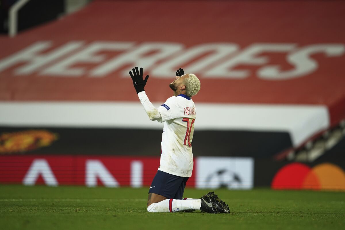 PSG's Neymar celebrates after scoring his side's third goal during a Group H Champions League soccer match between Manchester United and Paris Saint Germain at the Old Trafford stadium in Manchester, England, Wednesday, Dec. 2, 2020. (AP Photo/Dave Thompson)