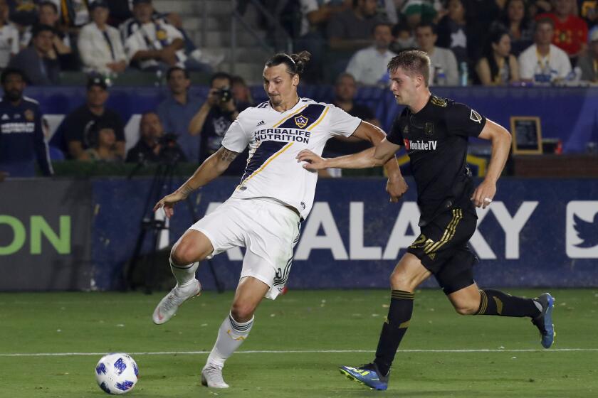 CARSON, CALIF. - AUG. 24, 2018. Galaxy forward Zlatan Ibrahimovic tries to get the ball inside against LAFC defender Walker Zimmerman in the second half Friday, Aug. 24, 2018, at StubHub Center in Carson. (Luis Sinco/Los Angeles Times)
