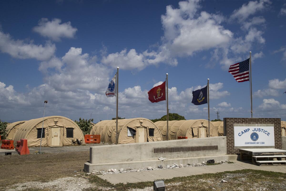 Flags fly in front of the tents of Camp Justice at Guantanamo Bay Naval Base.