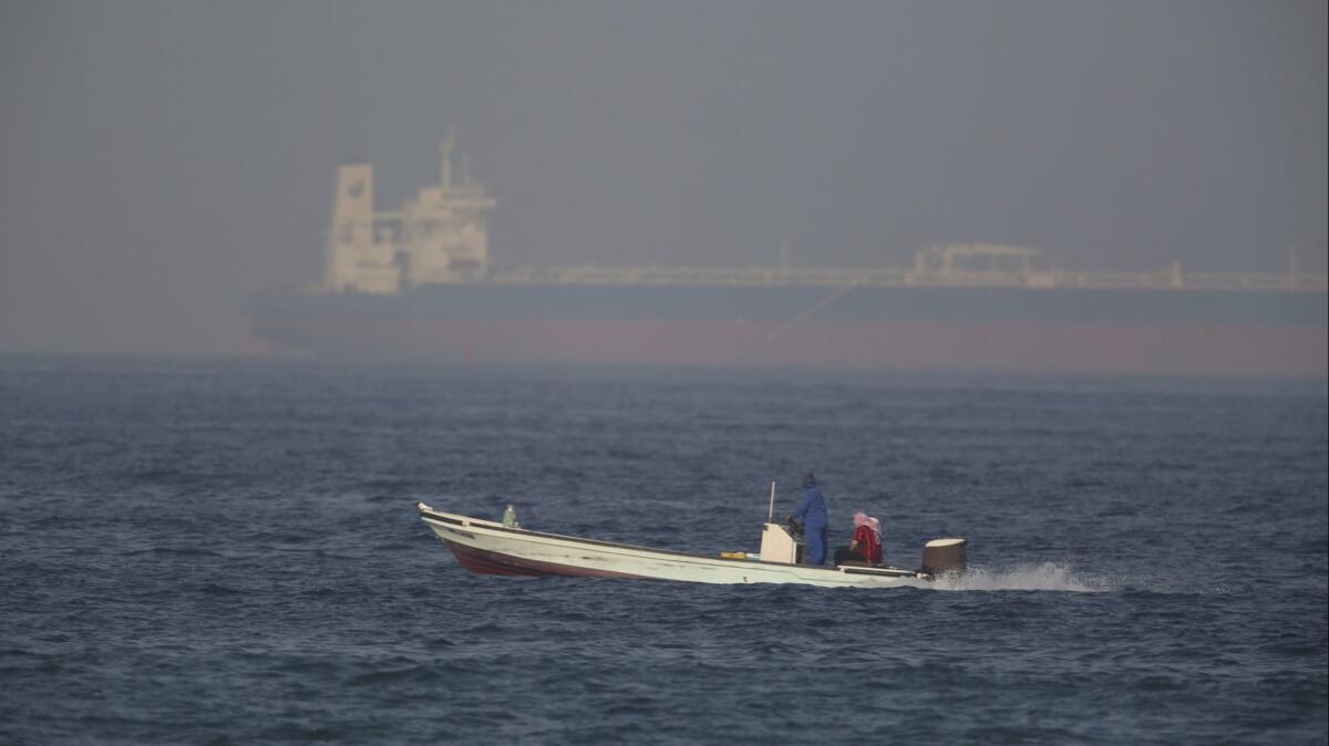A fishing boat and an oil tanker in the Gulf of Oman near the United Arab Emirates.