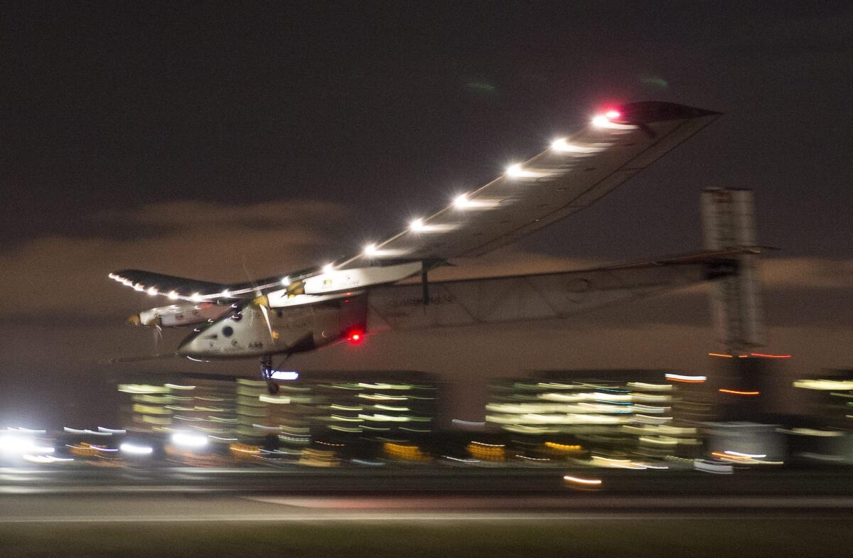 Solar Impulse 2, a solar powered plane piloted by Swiss adventurer Bertrand Piccard, lands just before midnight at Moffett Field in Mountain View on Saturday.