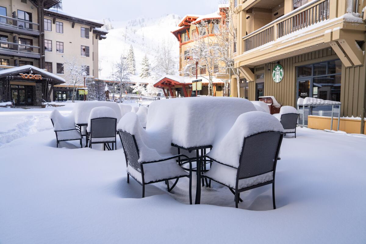 Snow piled up on the tables in the village at Palisades Tahoe.