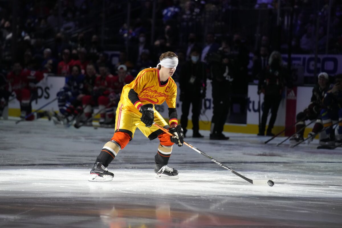 The Ducks' Trevor Zegras participates blindfolded in the Skills Competition Breakaway Challenge on Feb. 4, 2022. 