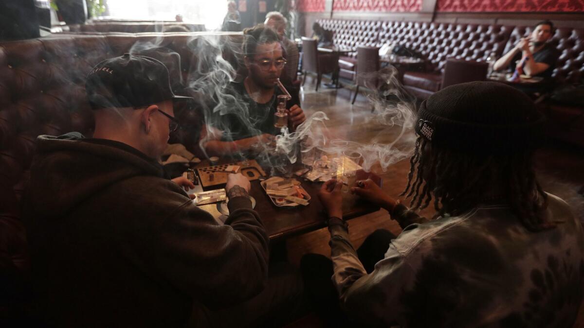 Customers smoke marijuana in the smoking lounge at Barbary Coast Collective in San Francisco. The city plans to issue more permits for marijuana lounges this year.