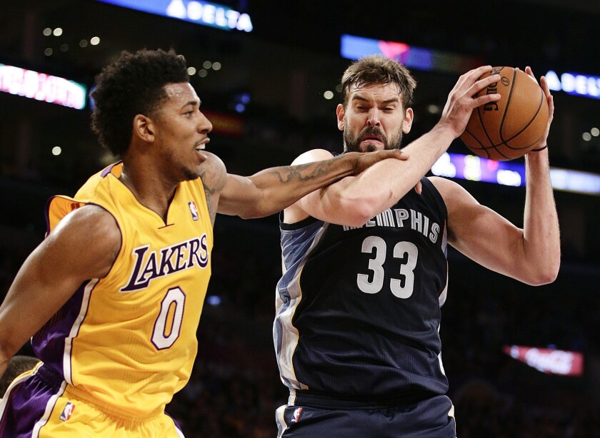 Memphis Grizzlies center Marc Gasol, right, grabs a rebound in front of Lakers forward Nick Young during the first half of Friday's game at Staples Center.