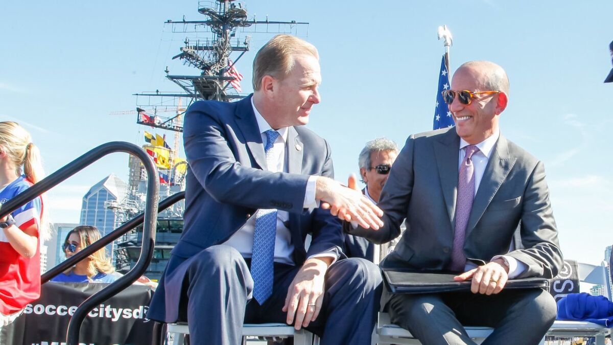 With application in hand, MLS Commissioner Don Garber (right) shakes hands with Mayor Kevin Faulconer during an MLS news conference on the USS Midway Museum on Jan. 30, 2017 -- 18 days after Dean Spanos announced he was moving the Chargers from San Diego to greater Los Angeles.