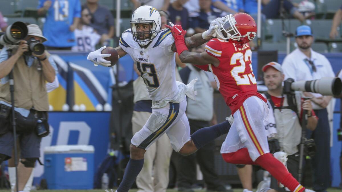 Chargers receiver Keenan Allen stiff arms Chiefs defensive back Kendall Fuller during a fourth quarter drive at StubHub Center.