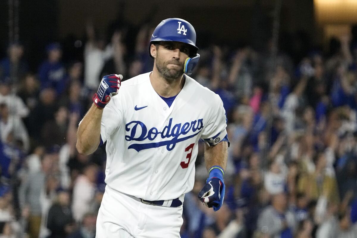 Dodgers' Chris Taylor gestures as he heads to first.
