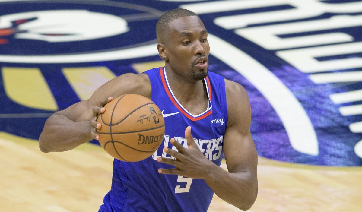 Los Angeles Clippers center Serge Ibaka (9) dribbles in the first half of an NBA basketball game.