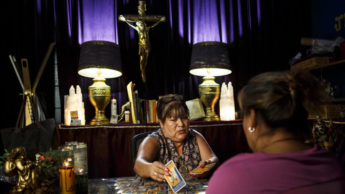 Maria Murillo Beltran reads tarot cards for a client.