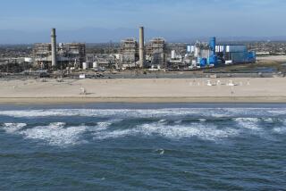 Huntington Beach, CA - April 5: An aerial view of the AES Huntington Beach Energy Center, the proposed site of the Poseidon Desalination Plant, which would draw ocean water through an existing intake pipe. In the background is neighboring residential community, Edison Community Park, Edison High School, ASCON toxic State superfund cleanup site, the proposed Magnolia Tank Farm Lodge, restaurants, and retail, upper right, the Huntington Beach Wetlands, middle right, and Huntington State Beach. Photo taken Tuesday, April 5, 2022. The partially retired Huntington Beach Generating Station consists of four generating units but only unit 2 is still in commercial operation as a legacy unit and has an extension to operate through the end of 2023, issued by the California State Water Boards. Unit 2 runs to support peak demands and has a net output capacity of 225 megawatts. The 644 MW combined cycle gas turbine generator, shown in blue and white, began operation on June 25, 2020. Environmental groups have fought Poseidon, arguing that it is privatizing a public resource, has failed to adapt an old proposal to new state ocean protections from killing sea life and that the company is trying to fill a need that doesn't exist, uses too much natural gas energy. Environmental justice activists say water rates could be raised as much as $6 per month. Supporters say ocean desalination as an inexhaustible, local supply for a region that imports much of its water from increasingly unreliable, distant sources. Another stumbling block for Poseidon is state requirements to mitigate the project's harm to the marine environment. Poseidon would draw 106 million gallons a day of seawater through the huge offshore intake pipe, which would be screened, and use reverse osmosis membranes to rid the seawater of salt and impurities. That process would produce 56 million gallons a day of brine concentrate - roughly twice as salty as the ocean - which would be dumped back into the Pacific via a 1,500-foot discharge pipe equipped with outfall diffusers to promote mixing and dilution. The intake and discharge operations will take a toll on plankton, which plays a crucial role in the marine food chain, killing an estimated 300,000 microscopic organisms a day. (Allen J. Schaben / Los Angeles Times)