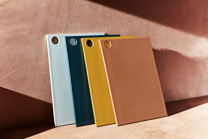 A set of colorful recycled cutting boards is seen.