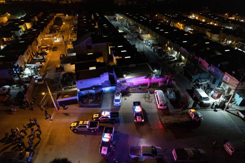 This aerial image taken on January 23, 2022 shows police cars guarding the crime scene where journalist Lourdes Maldonado was murdered in Santa Fe, Tijuana's outskirts, Baja California, Mexico. - A journalist was killed in Tijuana January 23, 2022, the local prosecutor said, the second media worker murdered in less than a week in the Mexican city on the US border. (Photo by Guillermo Arias / AFP) (Photo by GUILLERMO ARIAS/AFP via Getty Images)