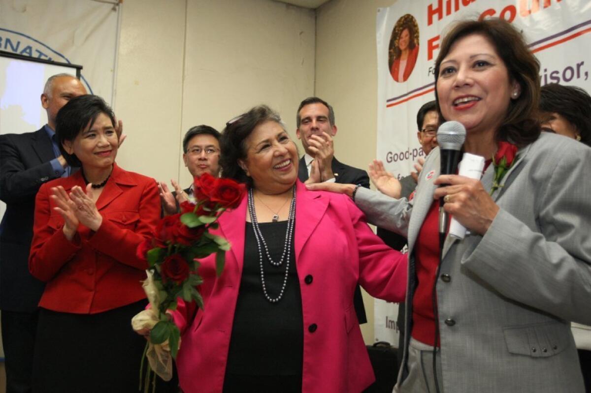 Hilda Solis, right, is seen next to outgoing L.A. County Supervisor Gloria Molina. Solis, who won her election outright Tuesday, will replace Molina on the Board of Supervisors.