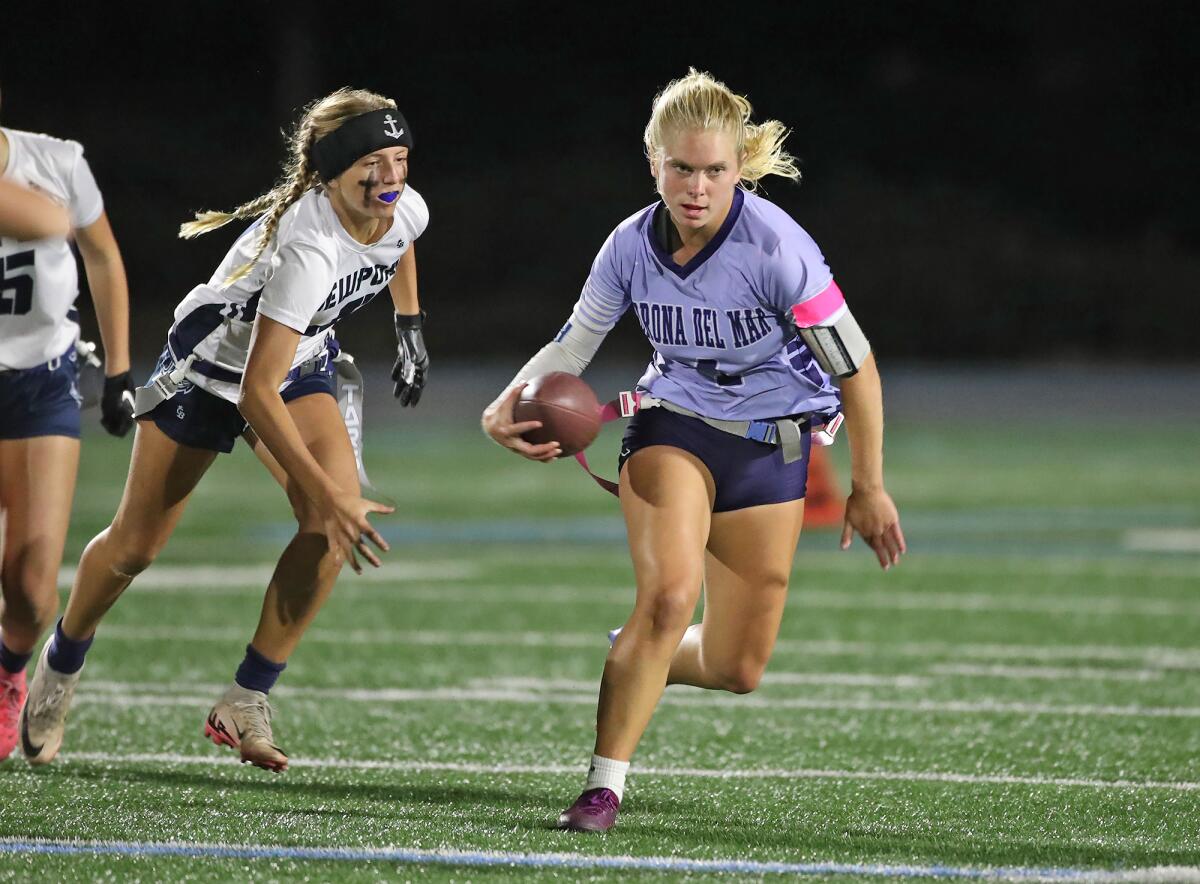 Corona del Mar quarterback Alexa Rokos (4) runs with the ball for a first down against Newport Harbor on Monday.