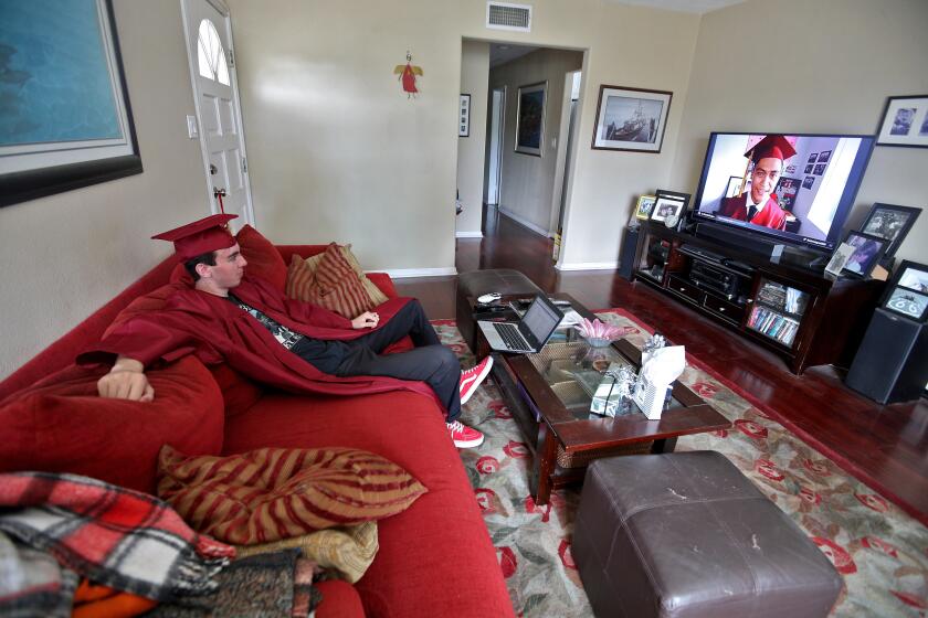 Estancia High graduate Michael Finicum watched the broadcast commencement ceremony on television at home in Costa Mesa on Wednesday, June 17, 2020.
