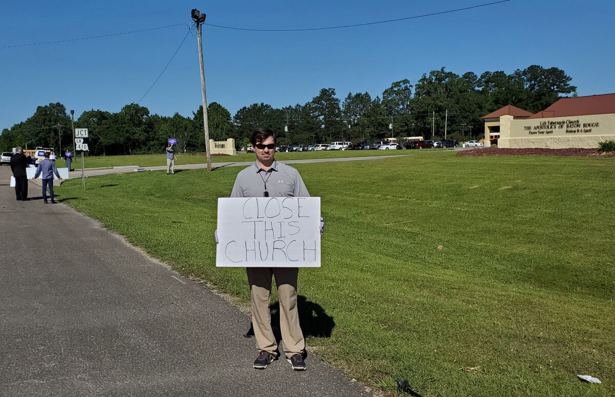 Trey Bennett protests at Life Tabernacle Church.