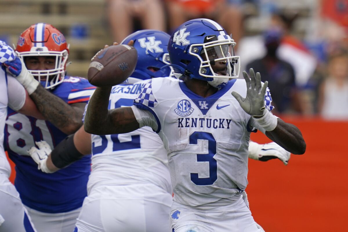 Kentucky quarterback Terry Wilson (3) looks for a receiver against Florida during the first half of an NCAA college football game, Saturday, Nov. 28, 2020, in Gainesville, Fla. (AP Photo/John Raoux)