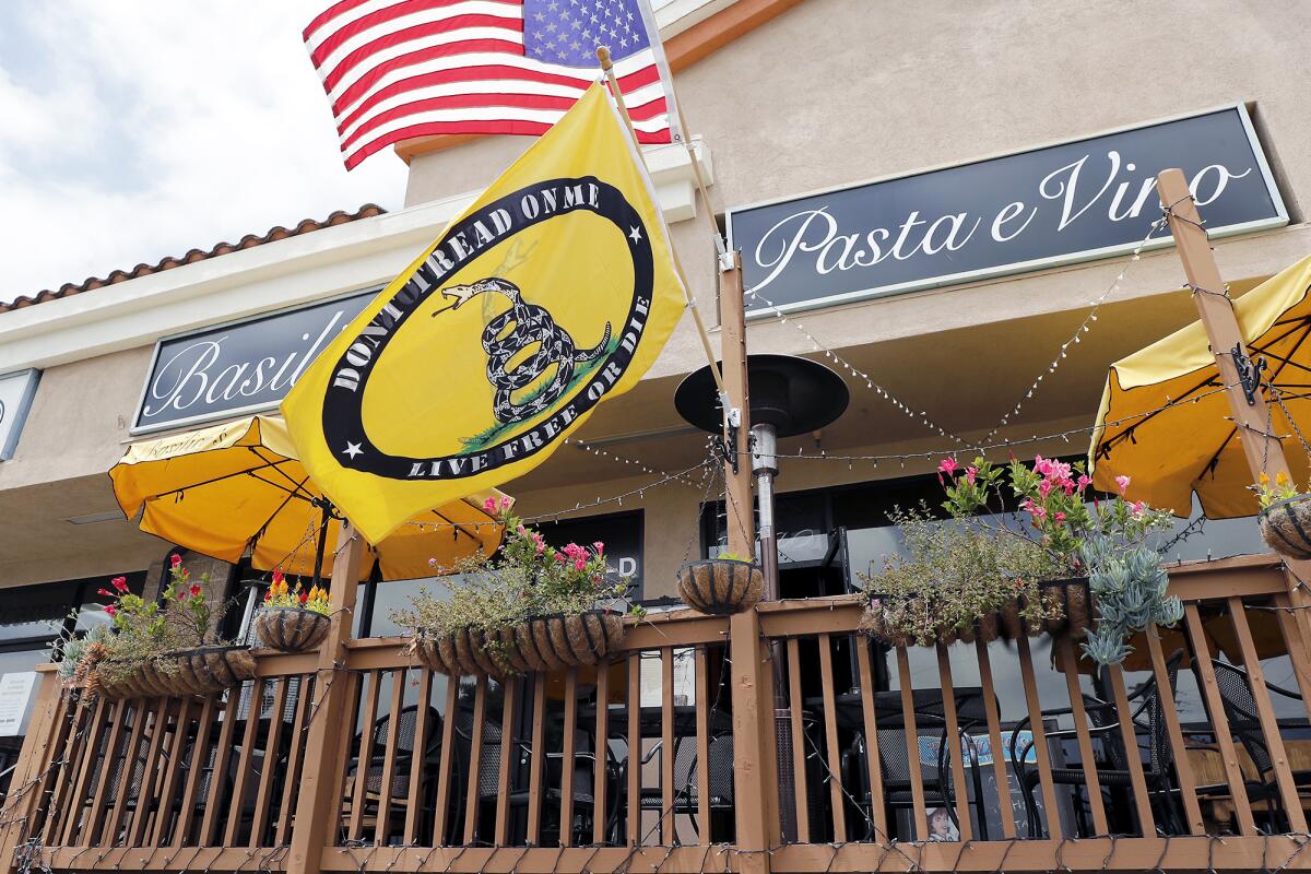 A Gadsden flag flies at Basilico's Pasta e Vino in Huntington Beach on Tuesday. 