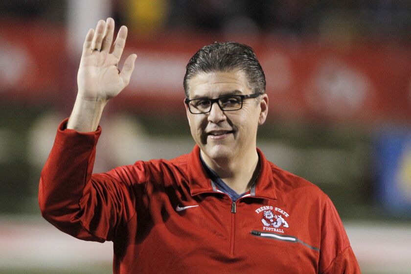 FILE - Joseph I. Castro, at the time president of Fresno State, waves to the crowd before the team's NCAA college football game Nov. 4, 2017, against BYU in Fresno, Calif. Castro mishandled sexual misconduct allegations while he headed the Fresno campus, according to a report released Thursday, Sept. 29, 2022. Castro failed to deal properly with complaints against Frank Lamas while Castro was Fresno State's president because he had a “blind spot” for his friend, according to the results of a months-long investigation commissioned by the California State University system. (AP Photo/Gary Kazanjian, File)