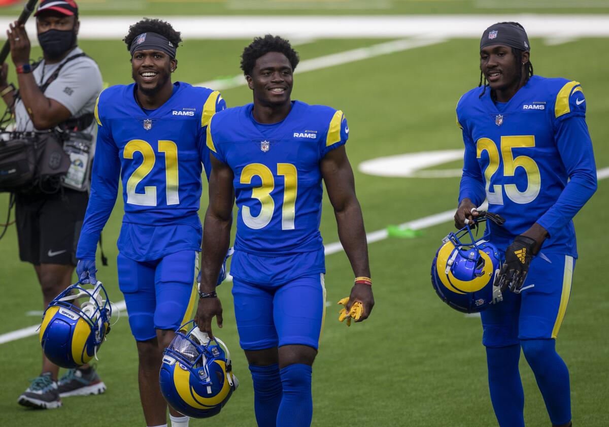 Cornerback Dont'e Deayon, left, takes the field with Rams teammates Darious Williams, center, and David Long Jr.